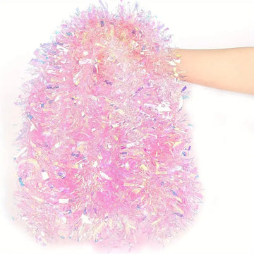 Hand holding fluffy pink tinsel garland with iridescent shimmer for festive decoration