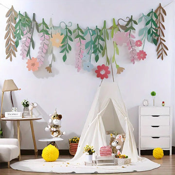 Pastel floral hanging banner decor in children's playroom with indoor teepee and plush toys