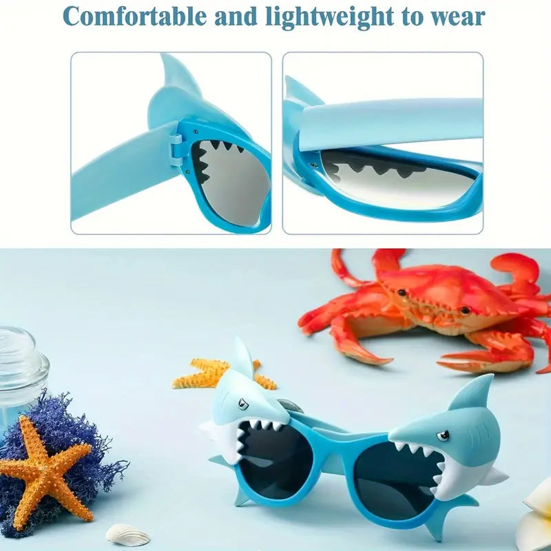 Shark-themed sunglasses on a beach with seashells and starfish, perfect for summer fun