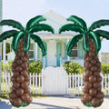 summer birthday party decor with palm tree balloon columns