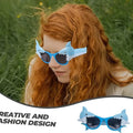Woman wearing shark sunglasses outdoors, showcasing the fun and creative design
