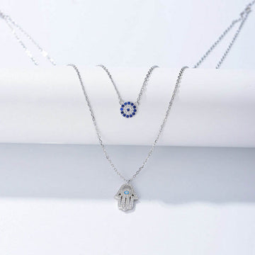 A meaningful layered necklace combining the power of the Hamsa Hand and the Evil Eye S925– believed to protect against negativity and bring blessings.