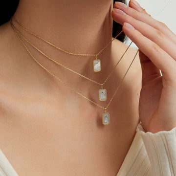 Elegant zodiac sign necklace made of 925 sterling silver and shimmering white mother-of-pearl. Available in all 12 signs – a perfect personalized gift for her