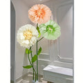 Decorative tissue paper flowers in pastel tones for elegant party styling.